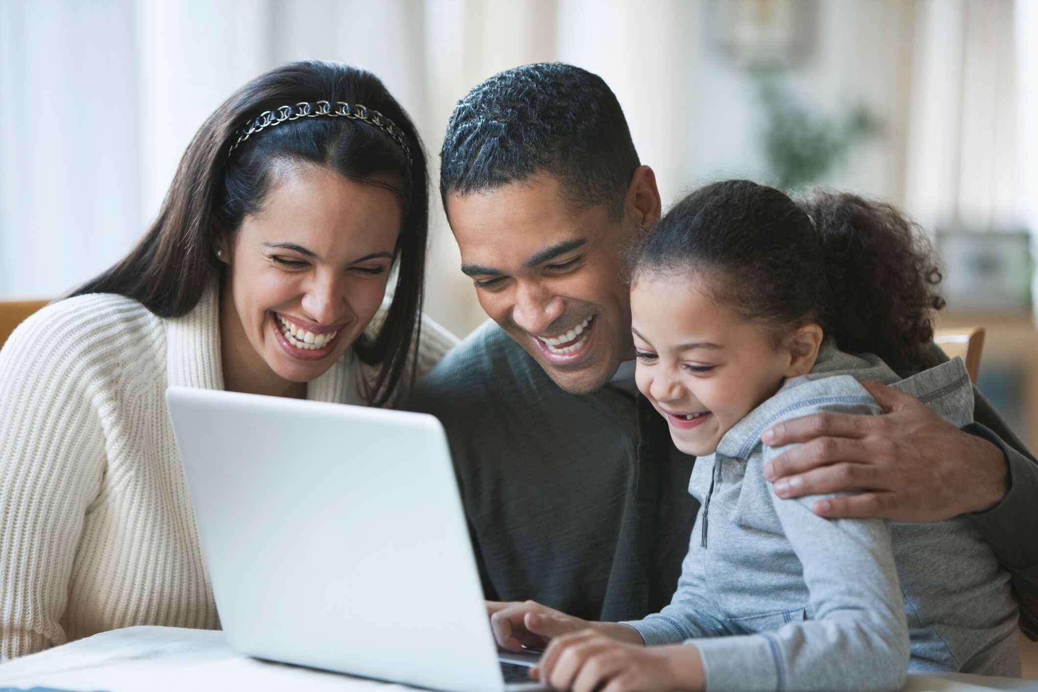 Family looking at laptop