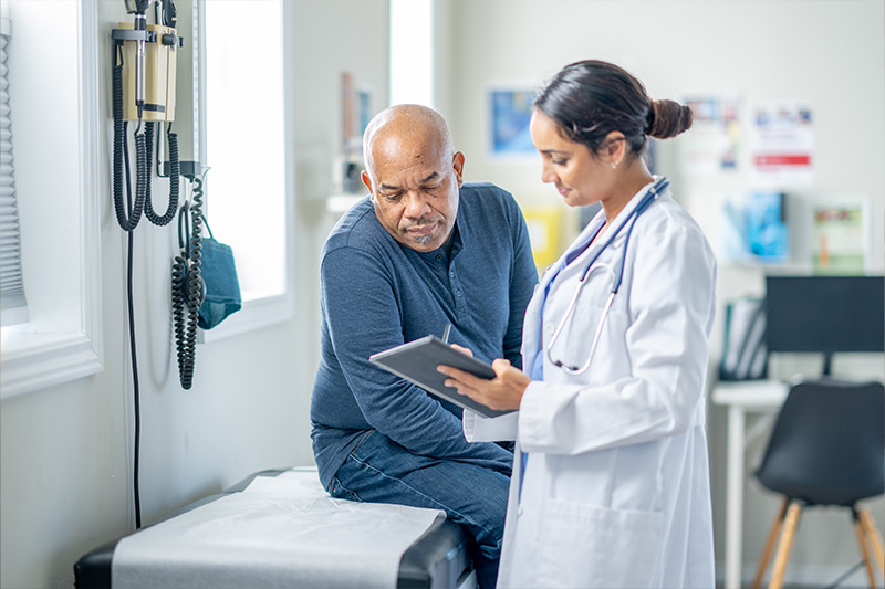 Doctor discussing the community pharmacy benefits at St. Mary's healthcare system with a patient.